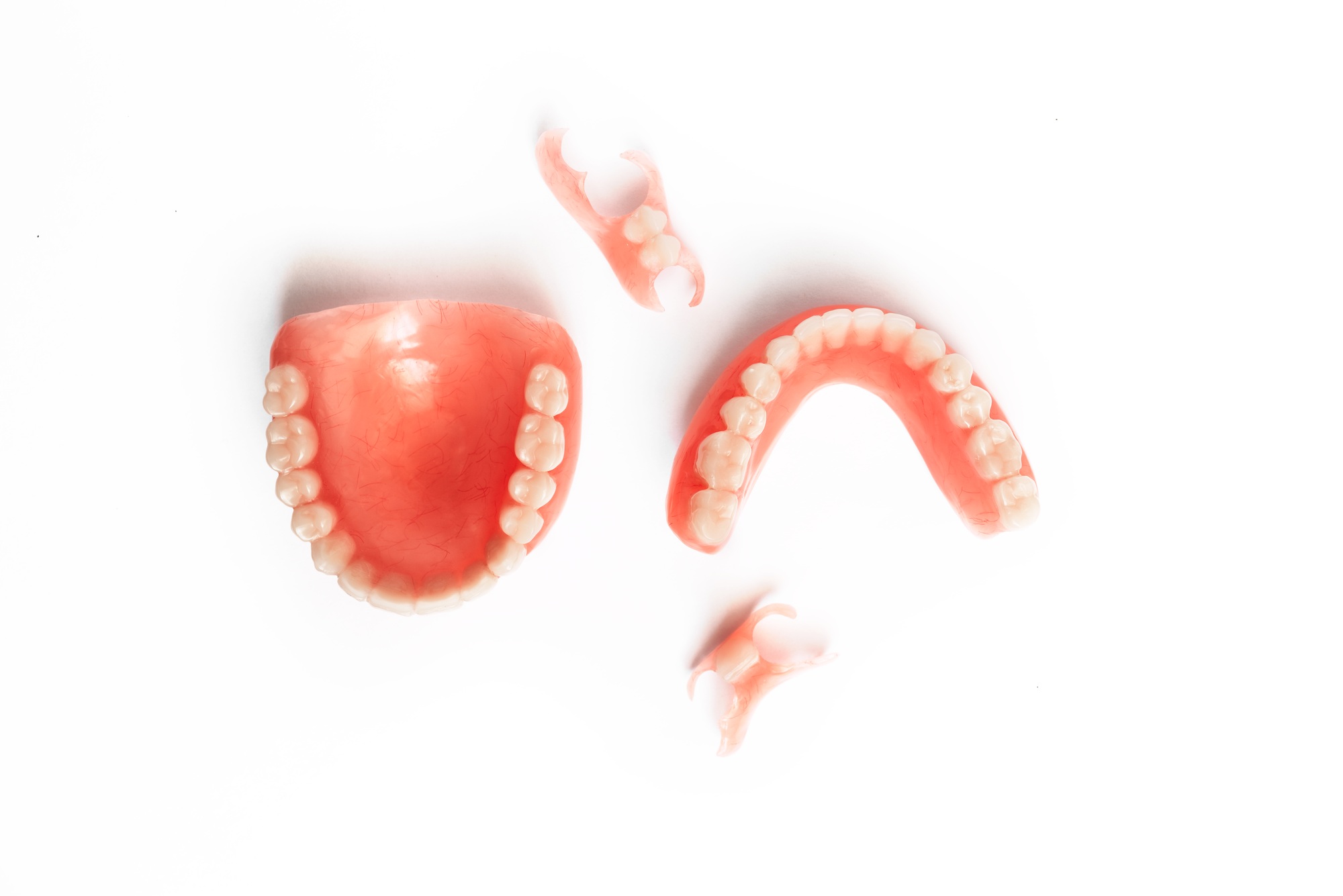 Dentures on a white background. Close-up of dentures. Full removable plastic denture of the jaws